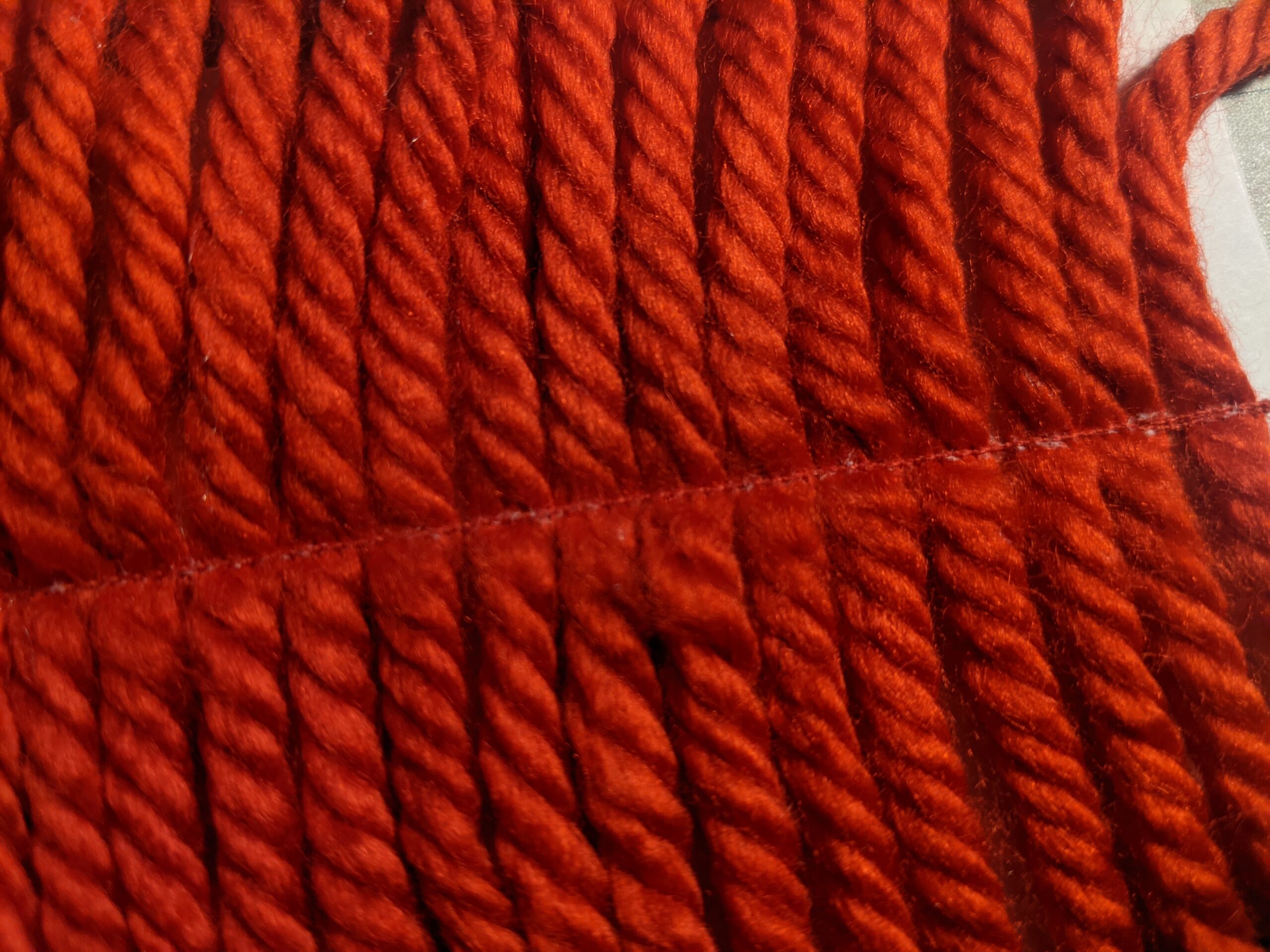 Red yarn sewn together side-by-side
